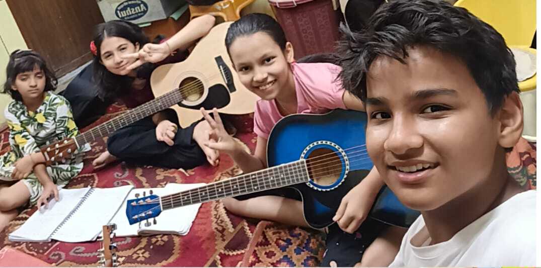 Students with guitars during a class at Natraj Sangeet Center